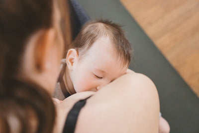 How can we minimize back pain and improve posture while breastfeeding?