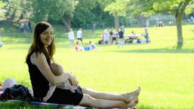 Breastfeeding in a parc with a black nursing dress